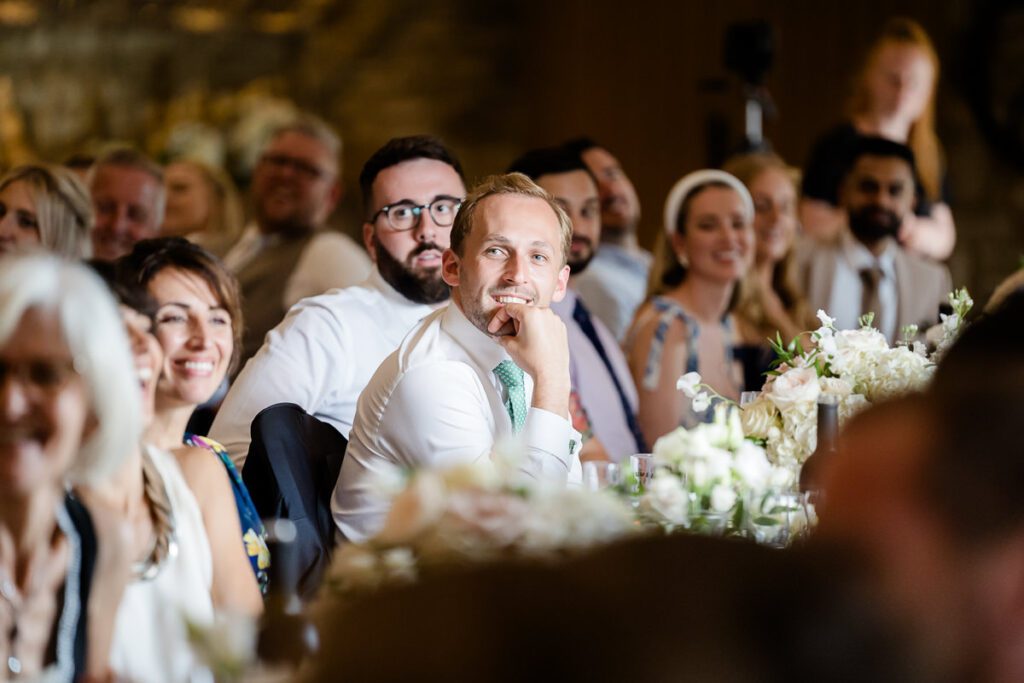 a guest looks on during wedding speeches at Caswell House