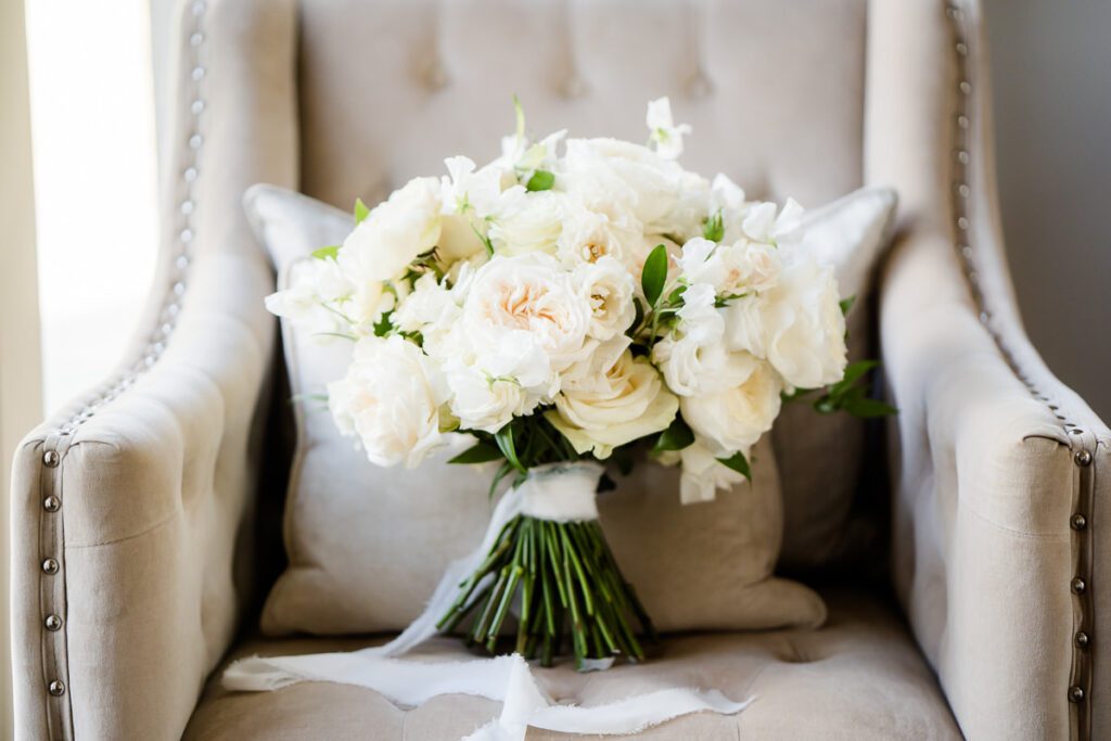Beautiful wedding bouquet of white roses in the honeymoon suite at Caswell House. Bouquet made by Joanna Carter Flowers.